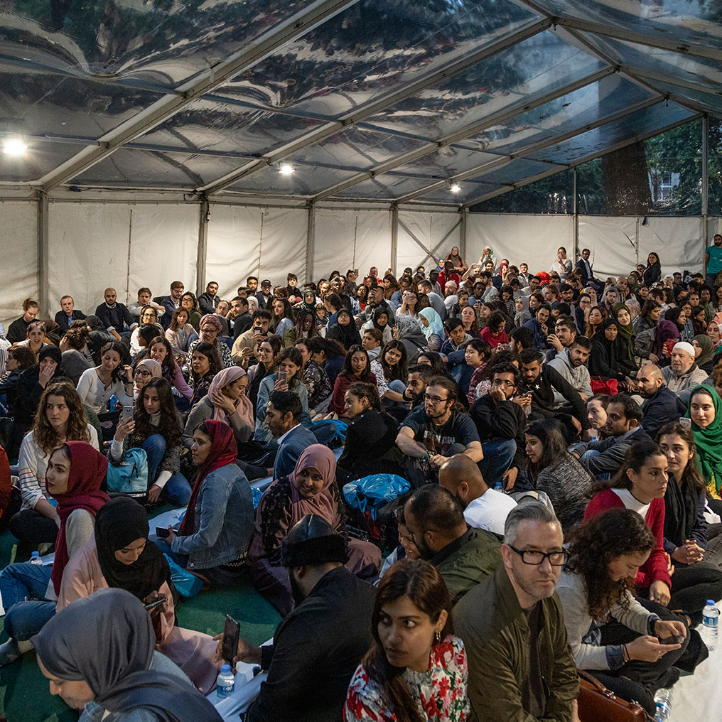 People sitting inside the Ramadan tent for iftar