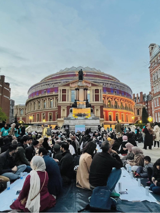 A of people sitting on ground for iftar in London