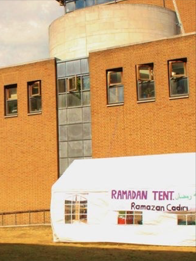 mscArtboard 80 White Ramadan tent along the side of road with huge building on the back.