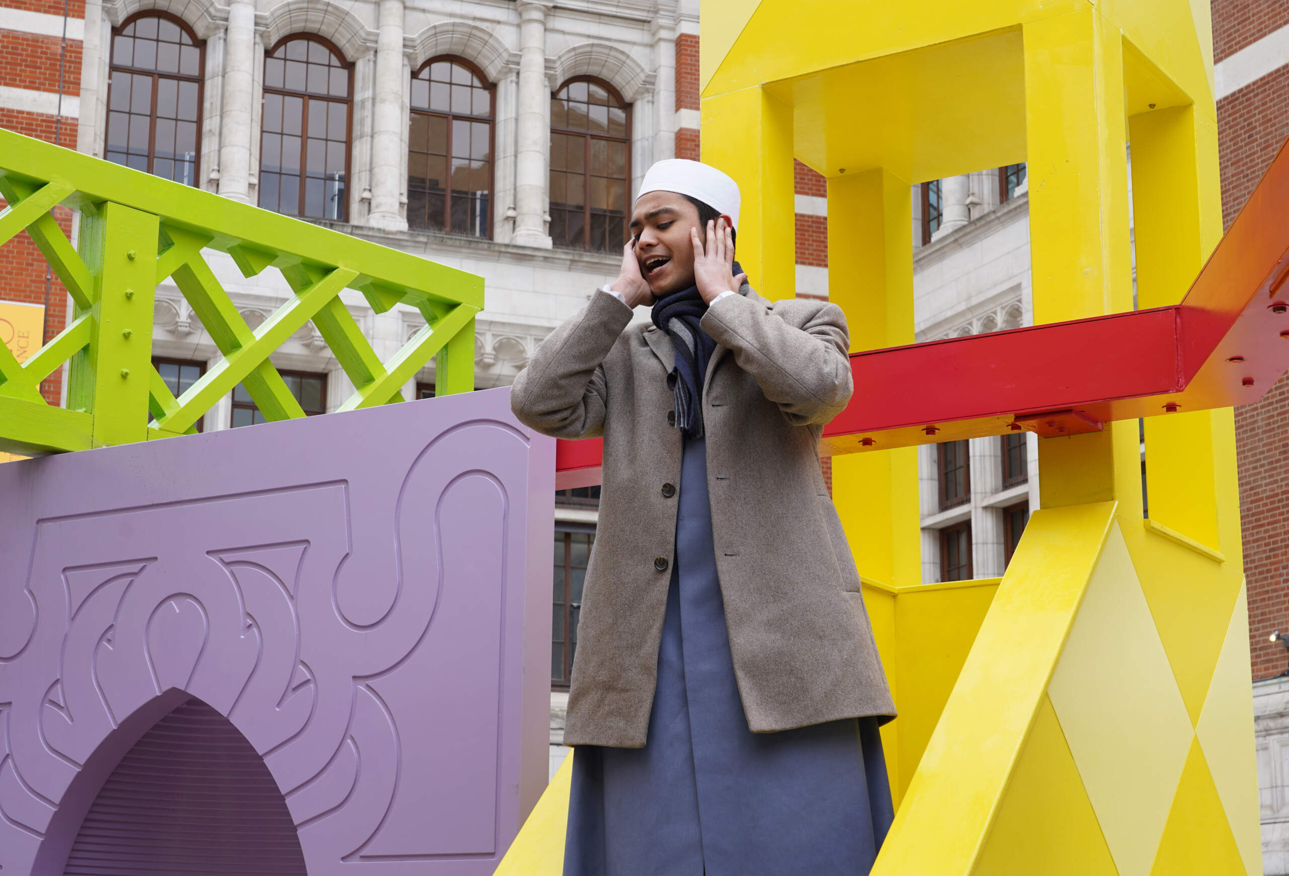 Man offering azan on "Ramadan Pavilion" at London's V&A