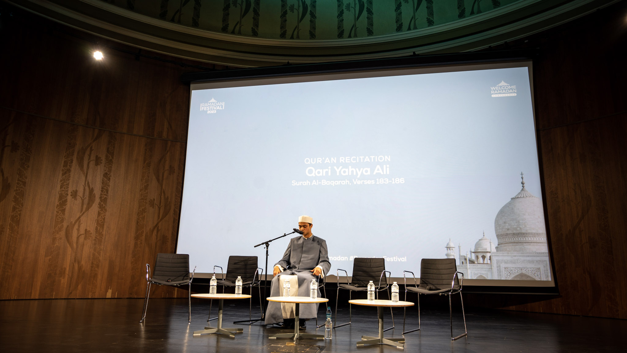 Photo of a man sitting on the chair in welcome Ramadan conference.